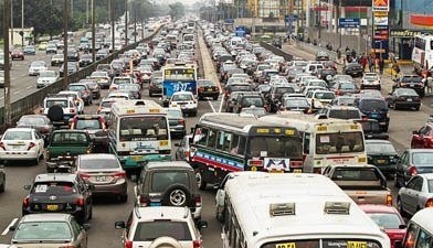 Crowded road with heavy traffic, appears to be poorly designed and causing traffic as a result.