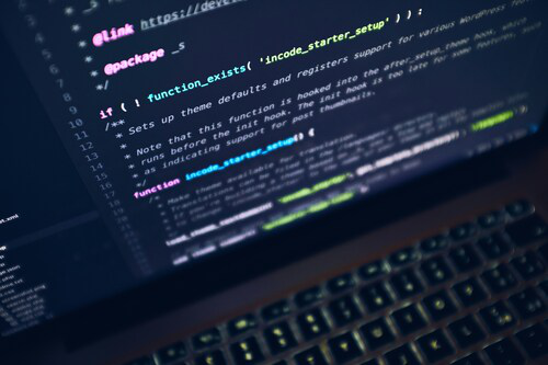 Photo of laptop with a coding environment on screen.
