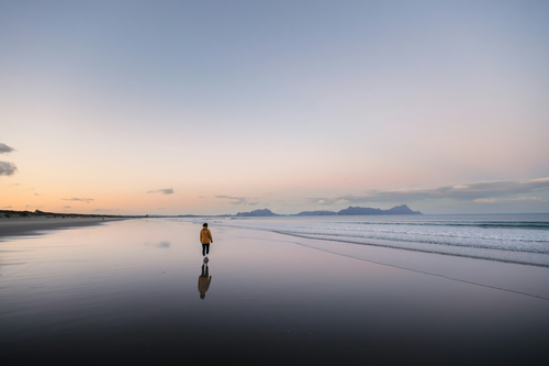 A man walking on the beach.